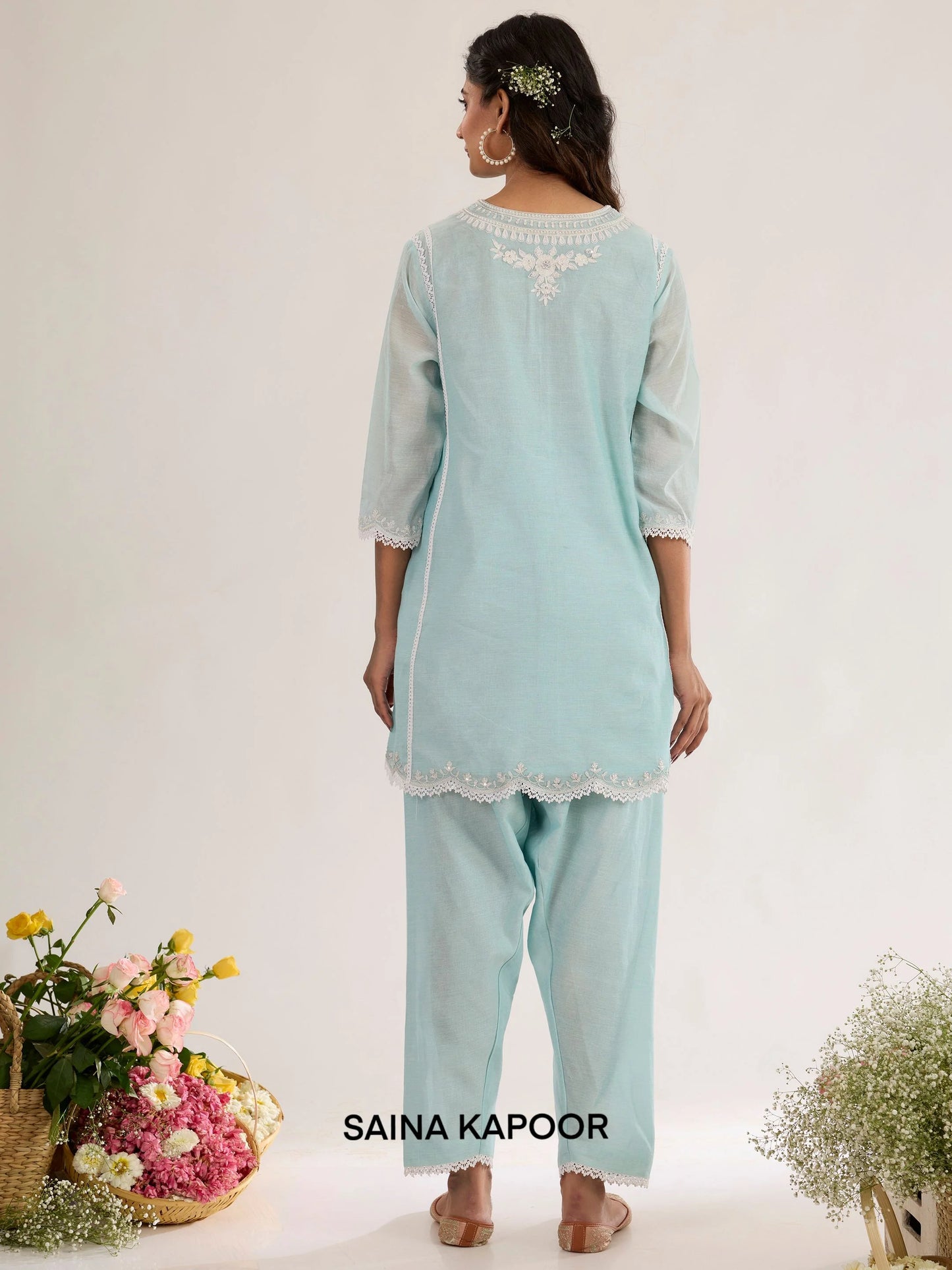 Ice blue Chanderi kurta back view with embroidered floral motif bordered in lace, three-quarter sleeves with lace-trimmed cuffs, and matching salwar - Saina Kapoor