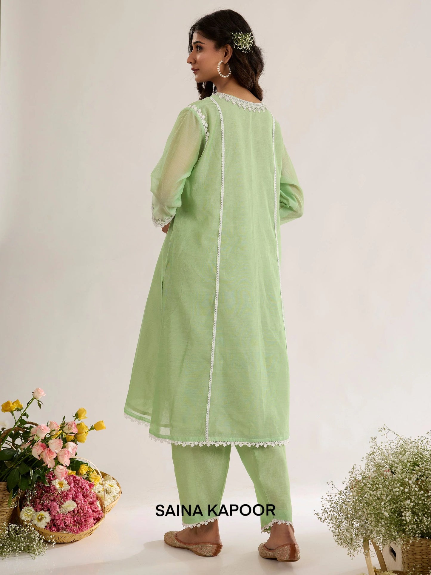 Mint green Chanderi kurta back view with round neckline bordered in lace, three-quarter sleeves with lace-trimmed cuffs, and matching salwar - Saina Kapoor