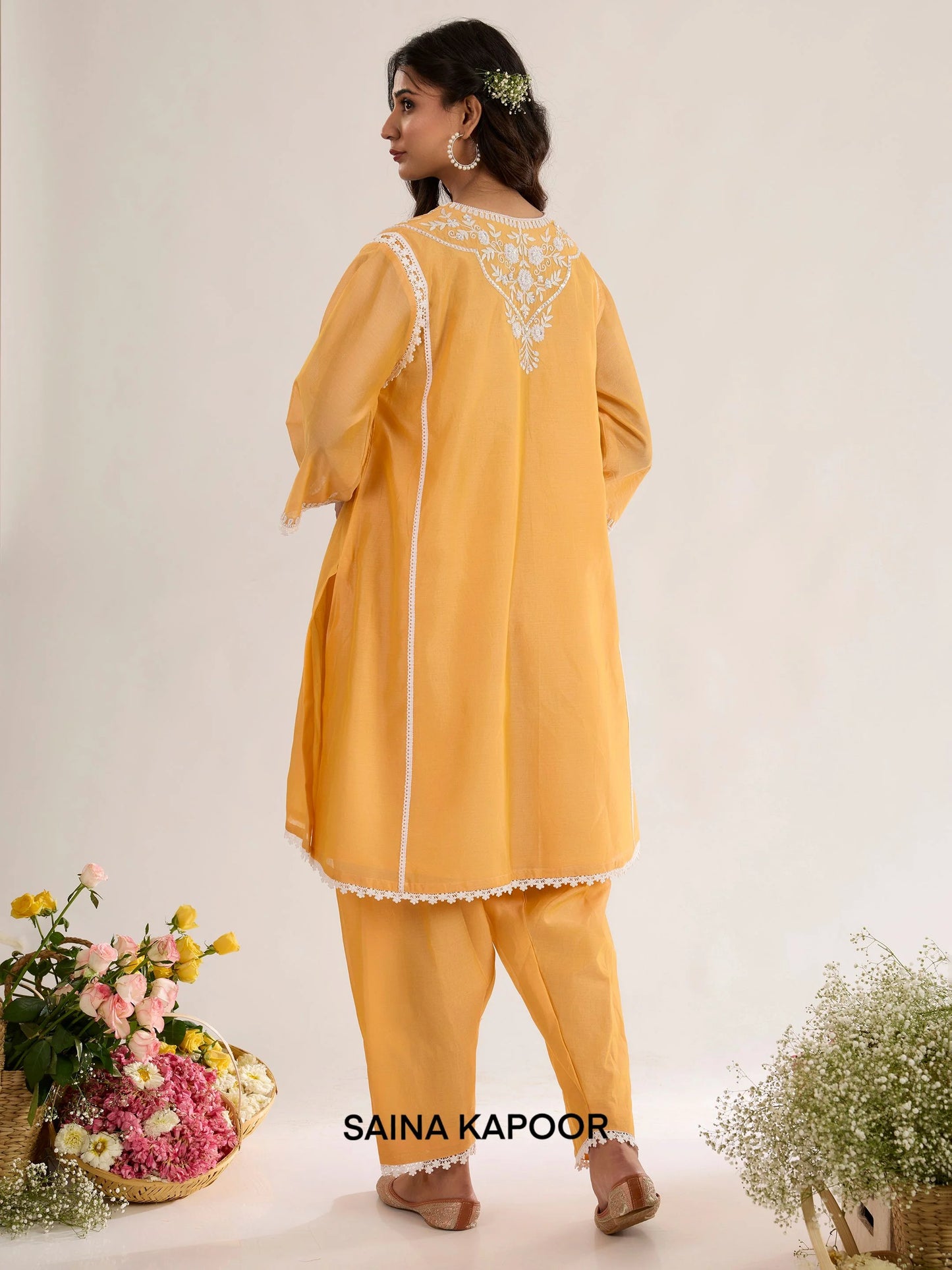 Golden Orange Chanderi kurta back view with Aari embroidered panel, three-quarter sleeves with lace-trimmed cuffs, and matching salwar - Saina Kapoor