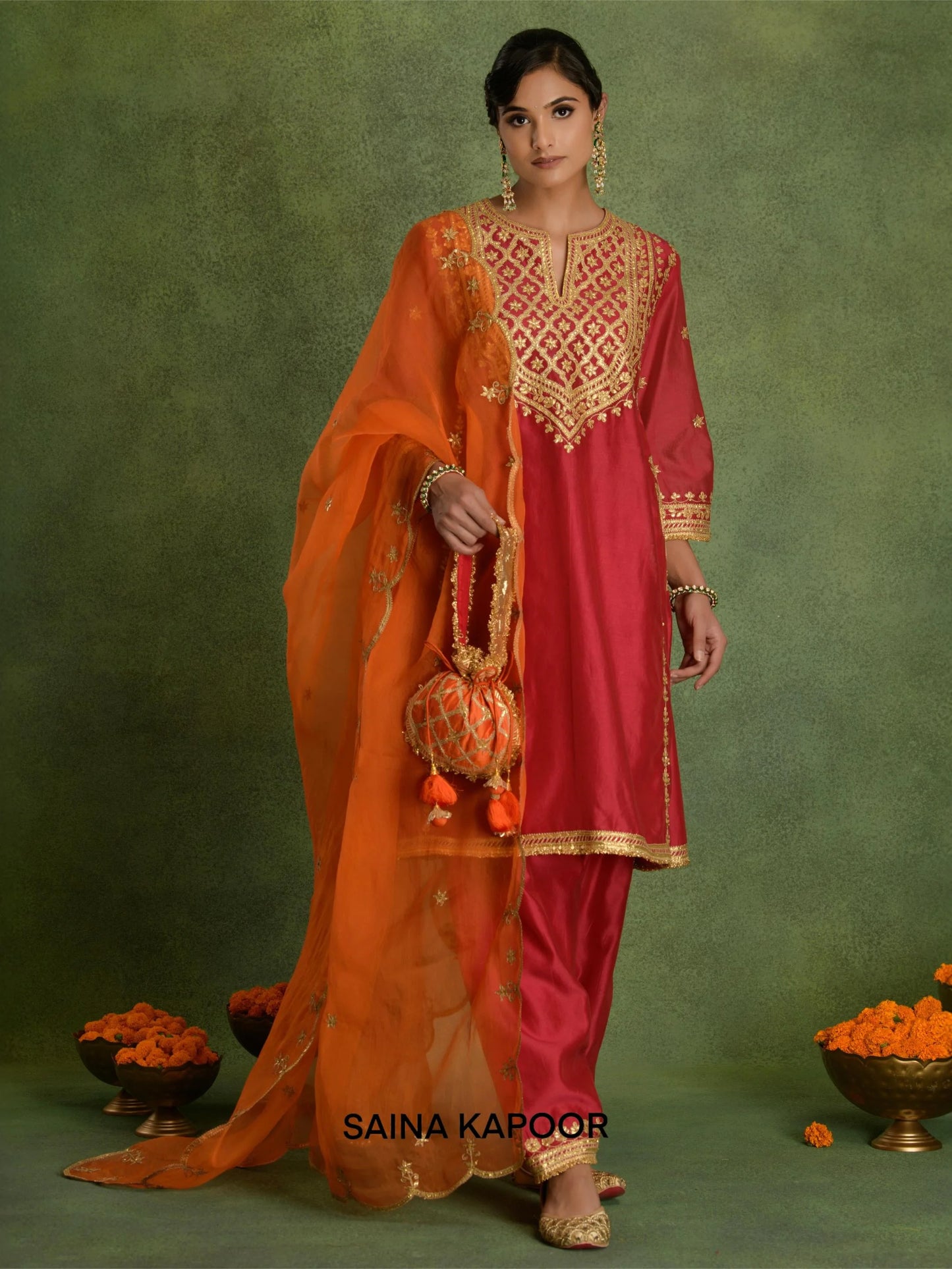 Fuchsia Chanderi short kurta DIYA with gold gota patti geometric trellis embroidered V-notch yoke, matching dhoti salwar with embroidered ankle cuffs, contrasting orange dupatta & potli bag — Saina Kapoor