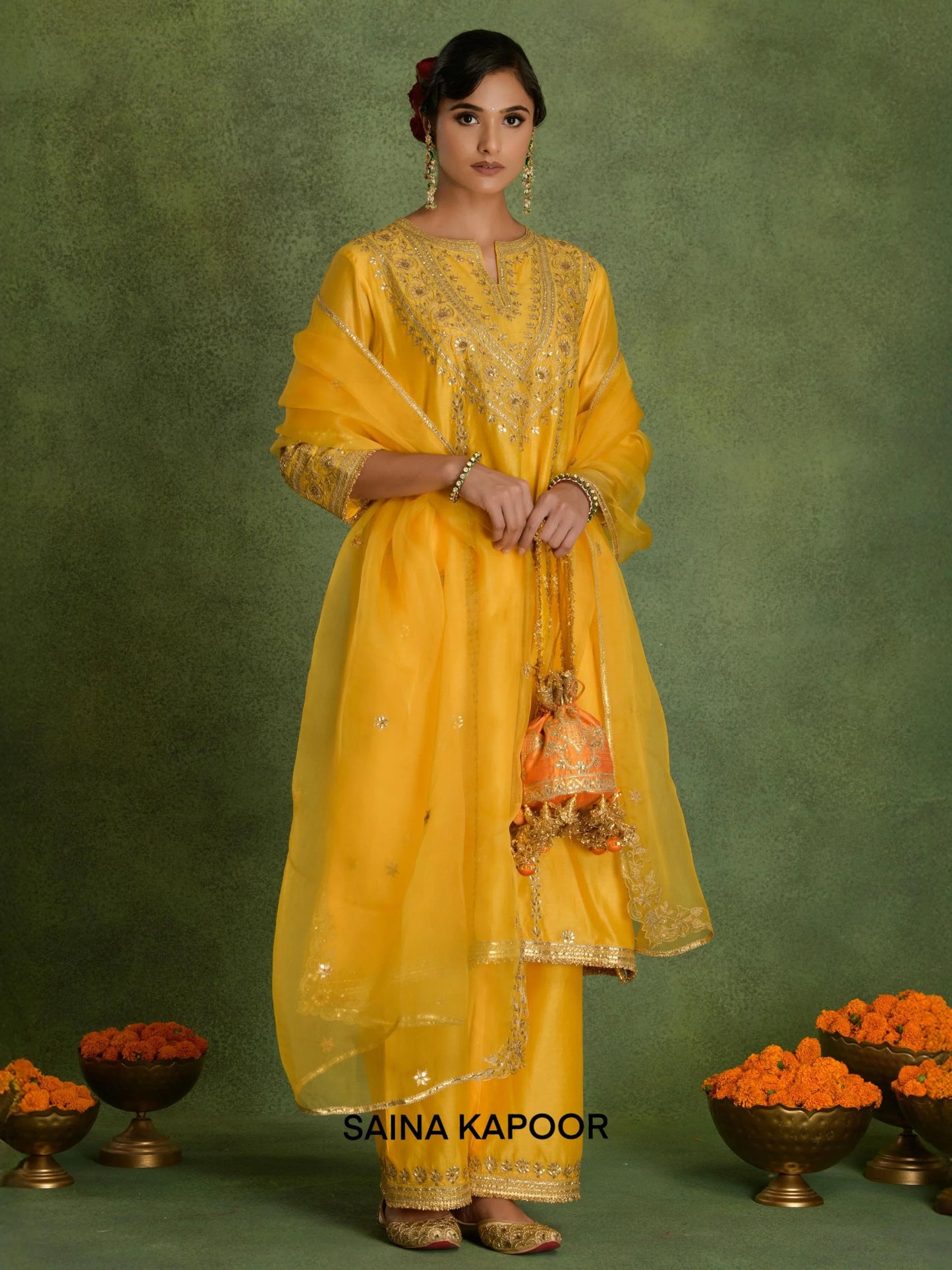 Yellow Chanderi A-line long kurta set with organza dupatta and potli by Saina Kapoor front view