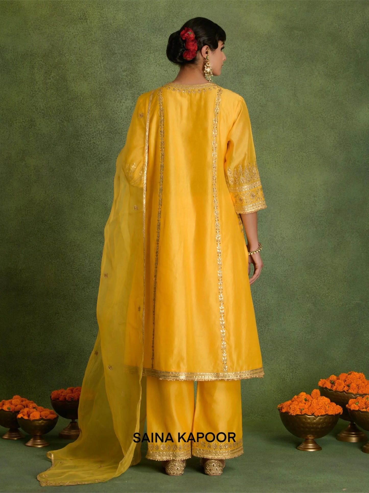 Back view of yellow Chanderi A-line kurta with pants and organza dupatta by Saina Kapoor