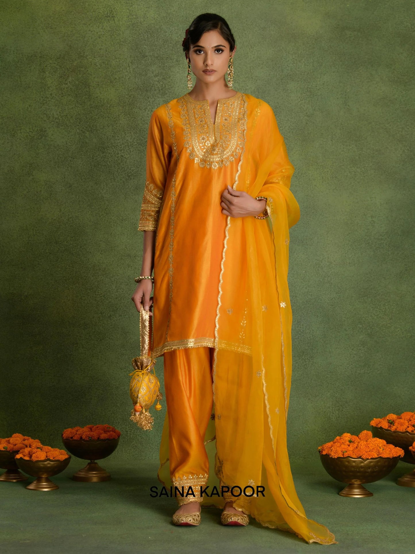 Orange Marigold Chanderi A-line kurta salwar set with organza dupatta and potli by Saina Kapoor