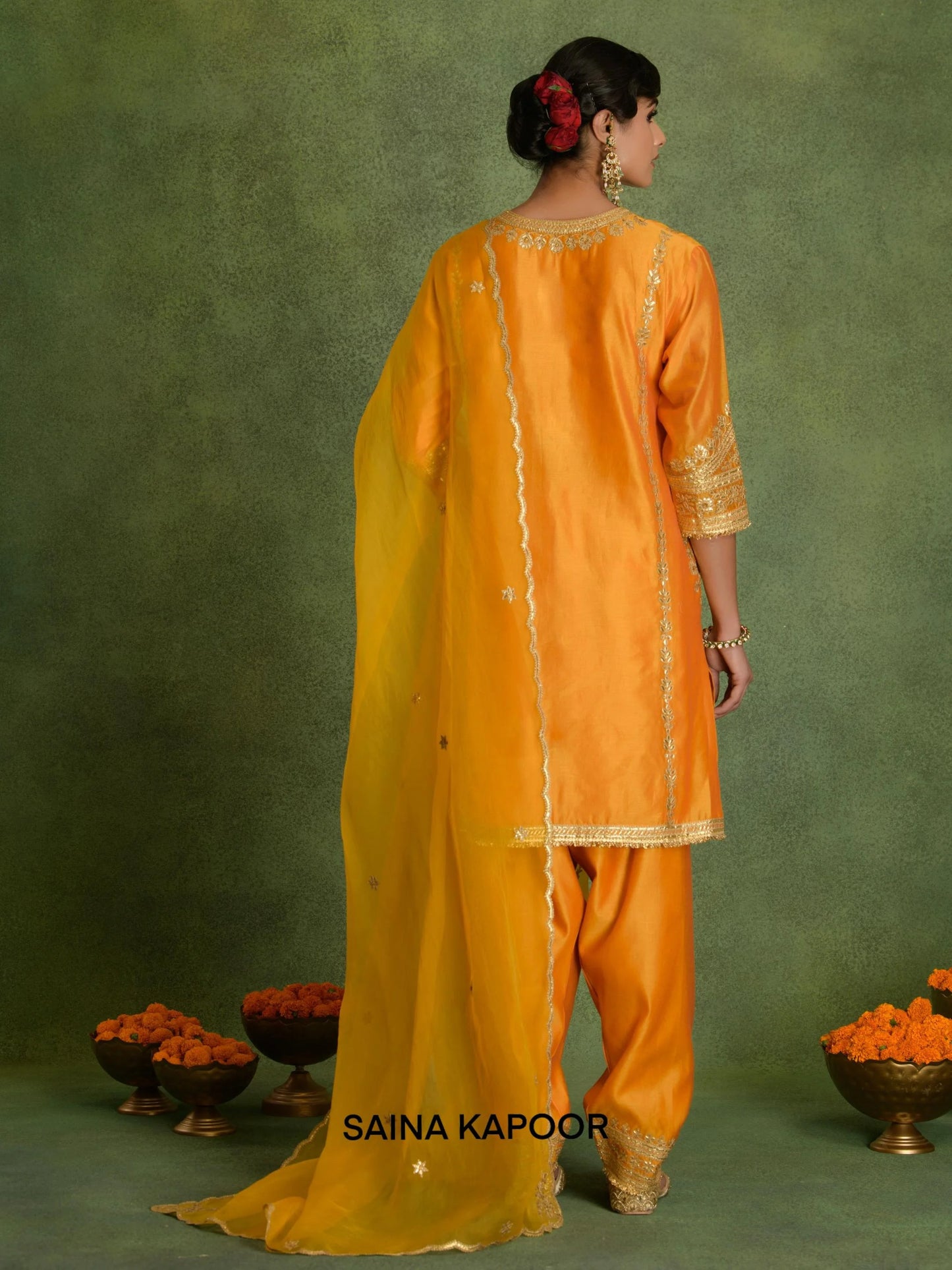 Back view of orange Chanderi A-line kurta with salwar and embroidered dupatta by Saina Kapoor