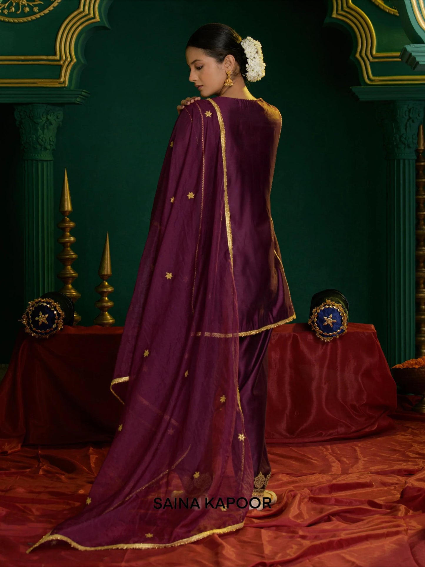 Back view of deep violet Chanderi short choga set for women with scattered sequin motif organza dupatta & gota patti embroidered ankle cuff salwar — Saina Kapoor