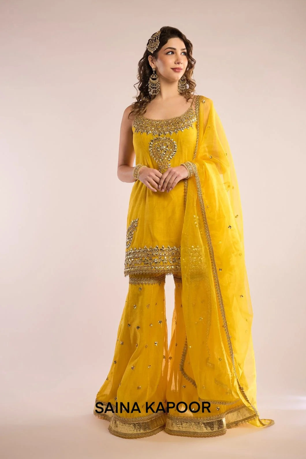 Yellow Chanderi sleeveless kurti with gota patti embroidered scoop neckline & matching gharara & yellow organza dupatta — Saina Kapoor
