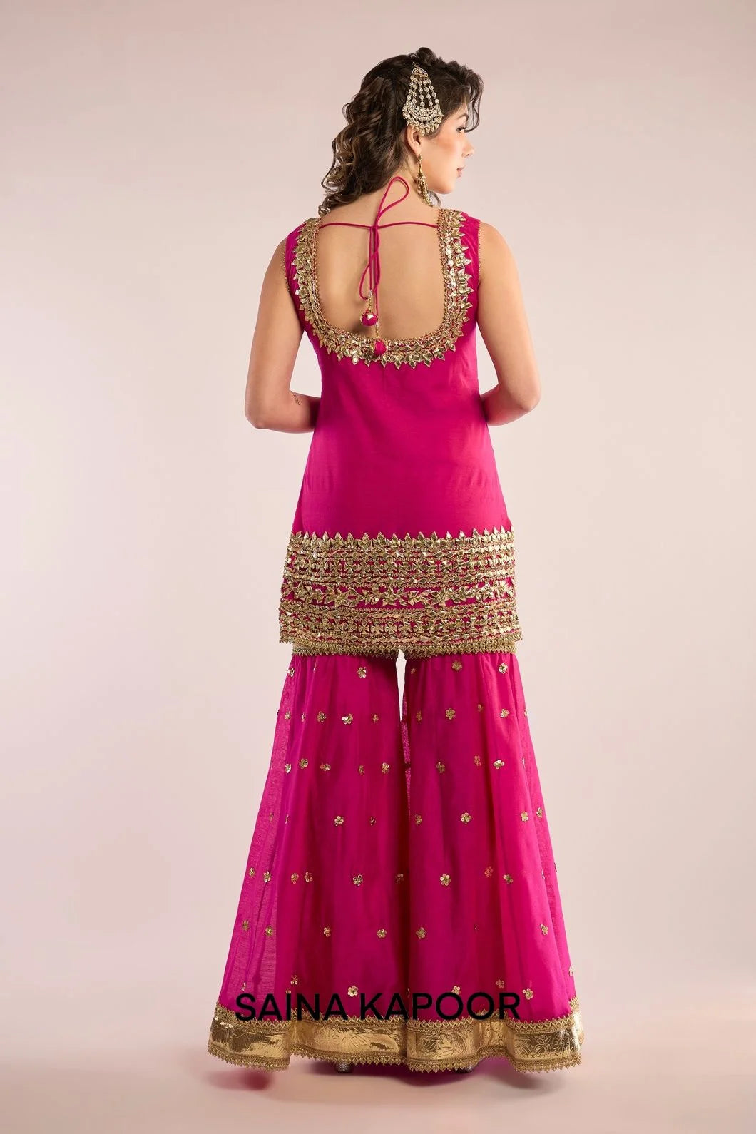 Back view of fuchsia Chanderi kurti gharara set for women with draped fuchsia organza dupatta — Saina Kapoor