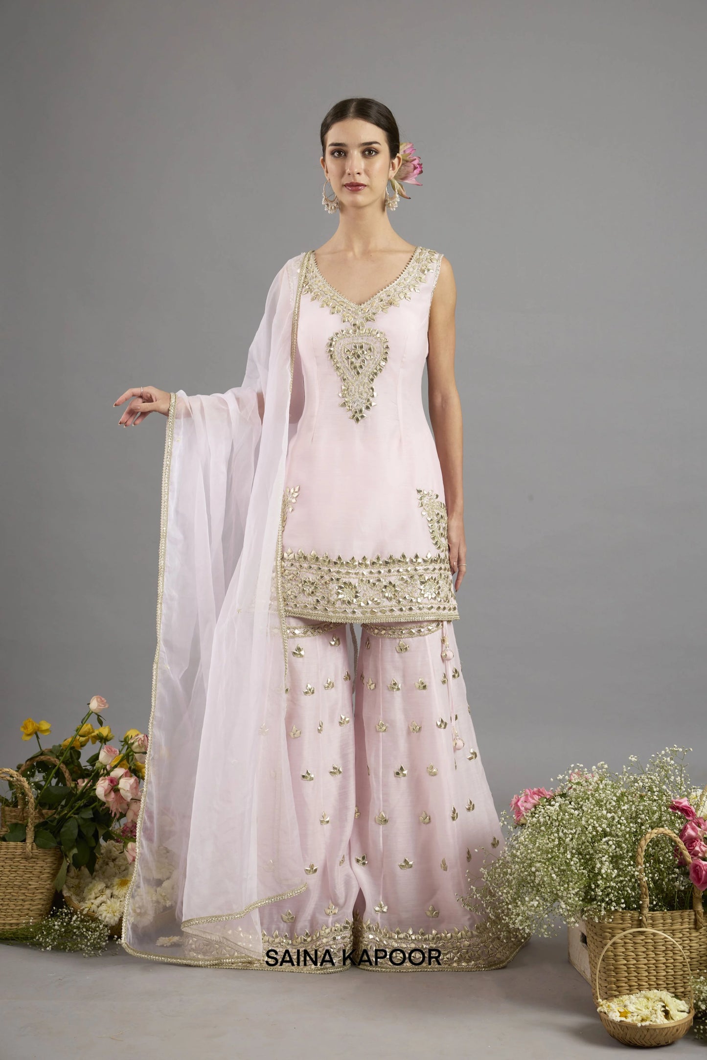 Areej soft pink Chanderi sleeveless kurta with gota patti V-neckline paired with matching flared gharara and organza dupatta - Saina Kapoor
