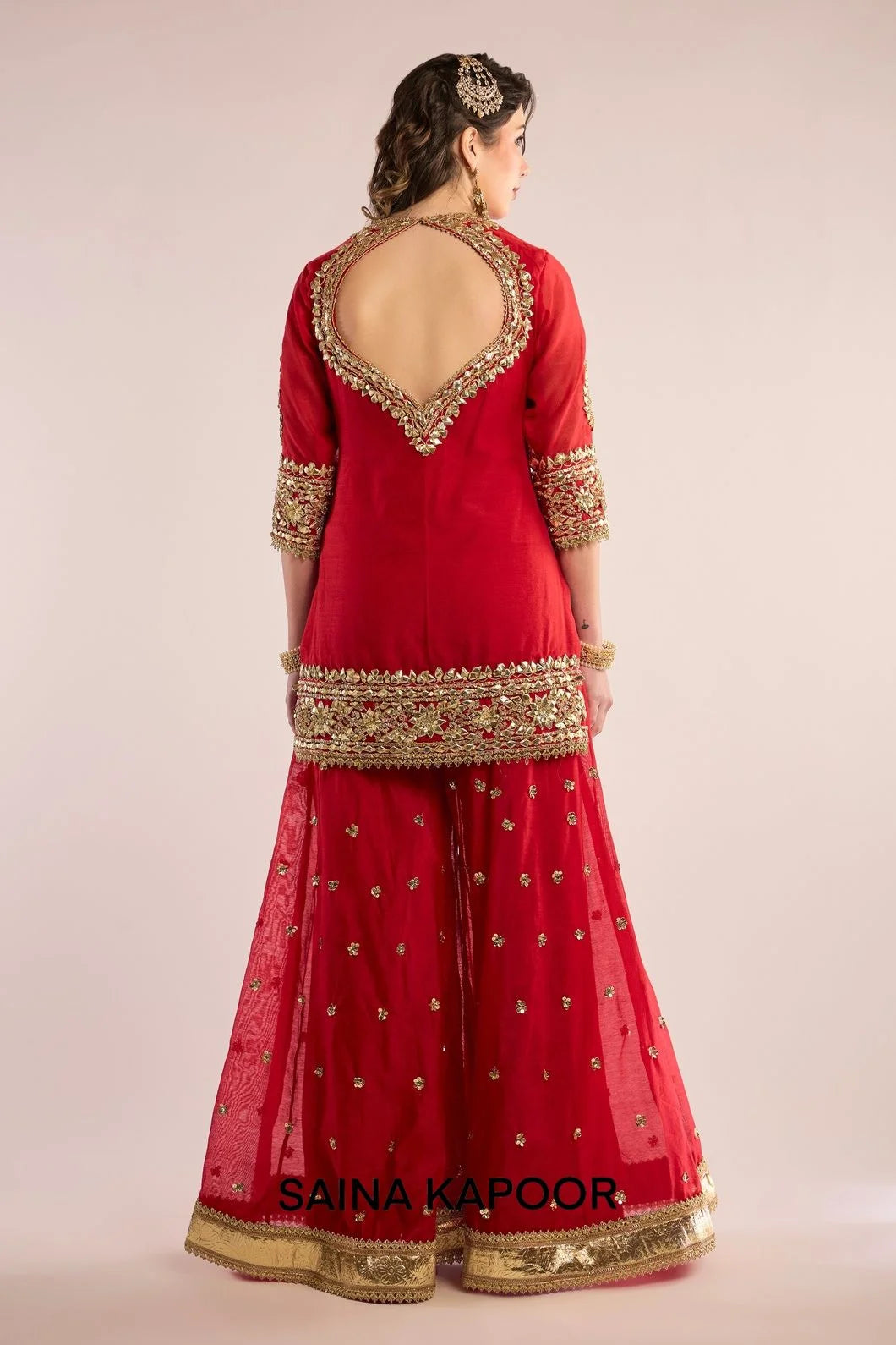 Back view of red Chanderi kurta sharara set for women with draped red organza dupatta — Saina Kapoor