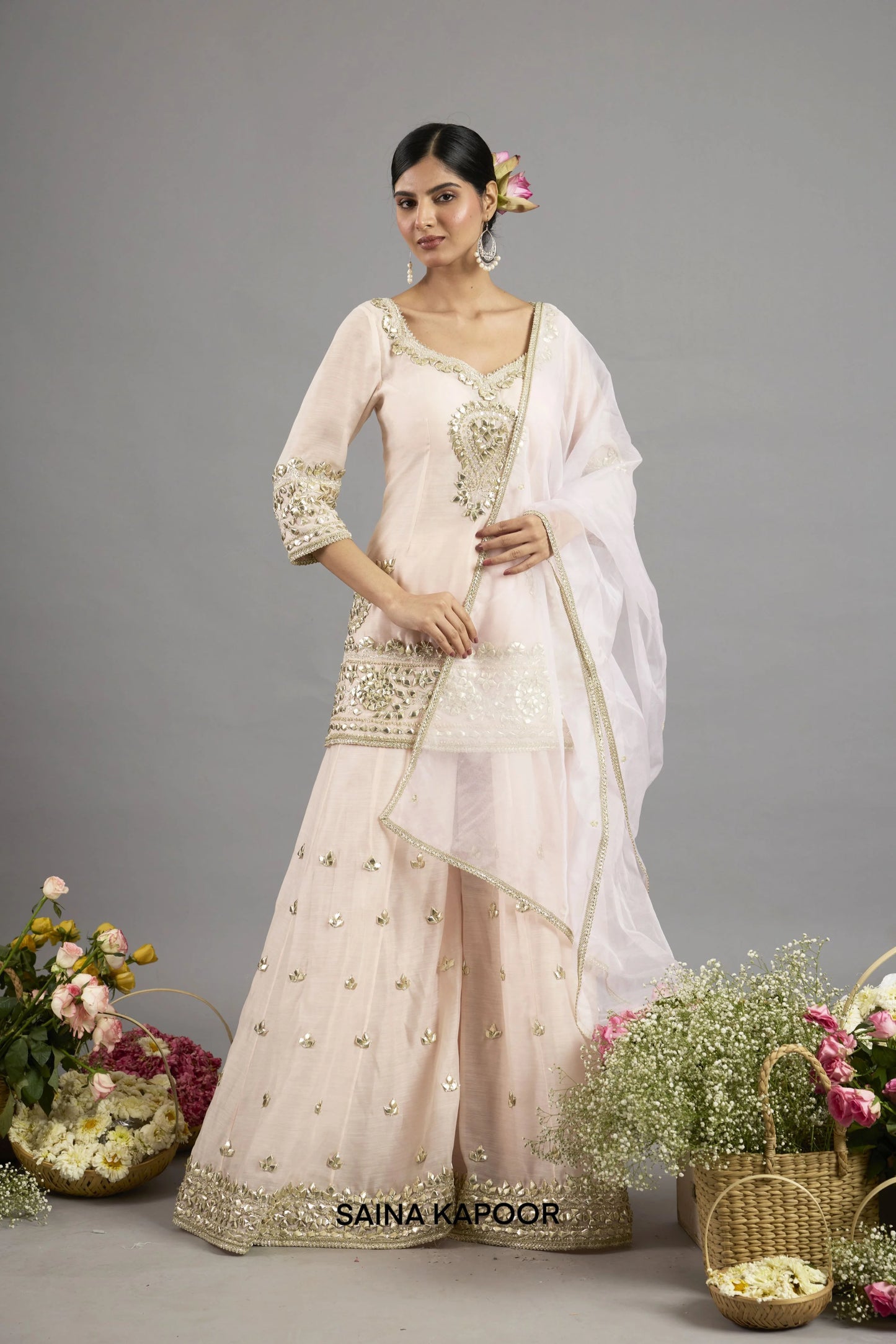 Asma peach pink Chanderi kurta with gota patti V-neckline paired with matching flared sharara and organza dupatta - Saina Kapoor
