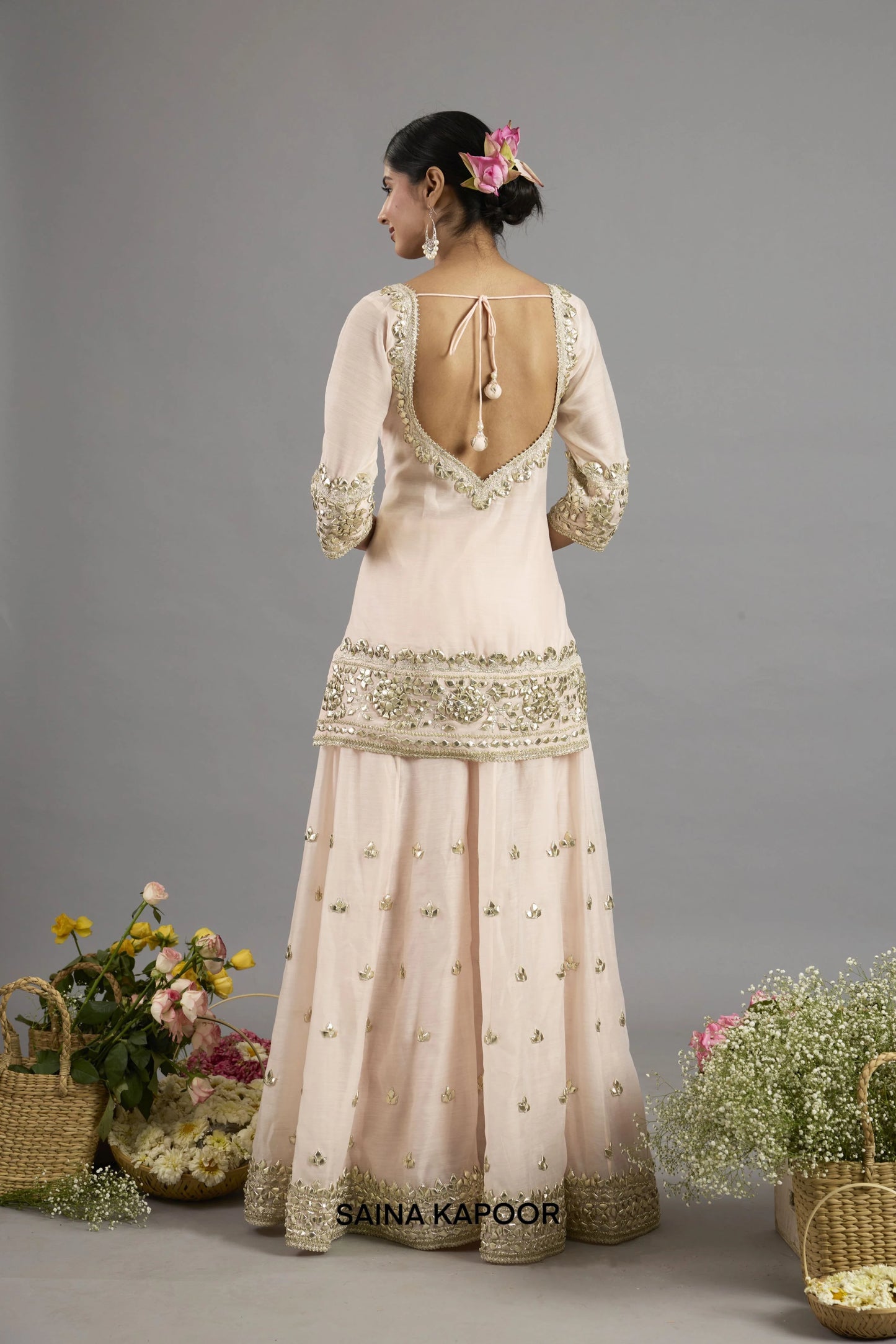 Asma kurta back view with deep V-neckline and tasseled tie closure bordered in gota patti embroidery - Saina Kapoor