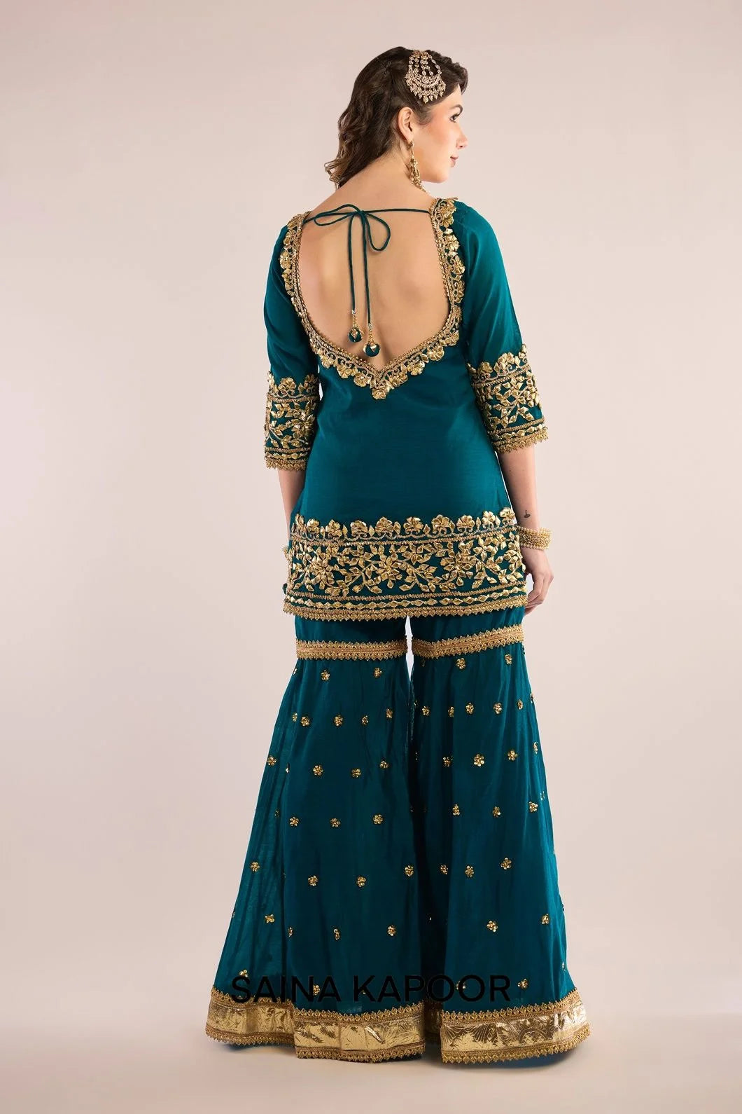 Back view of turquoise Chanderi kurta gharara set for women with draped turquoise organza dupatta — Saina Kapoor