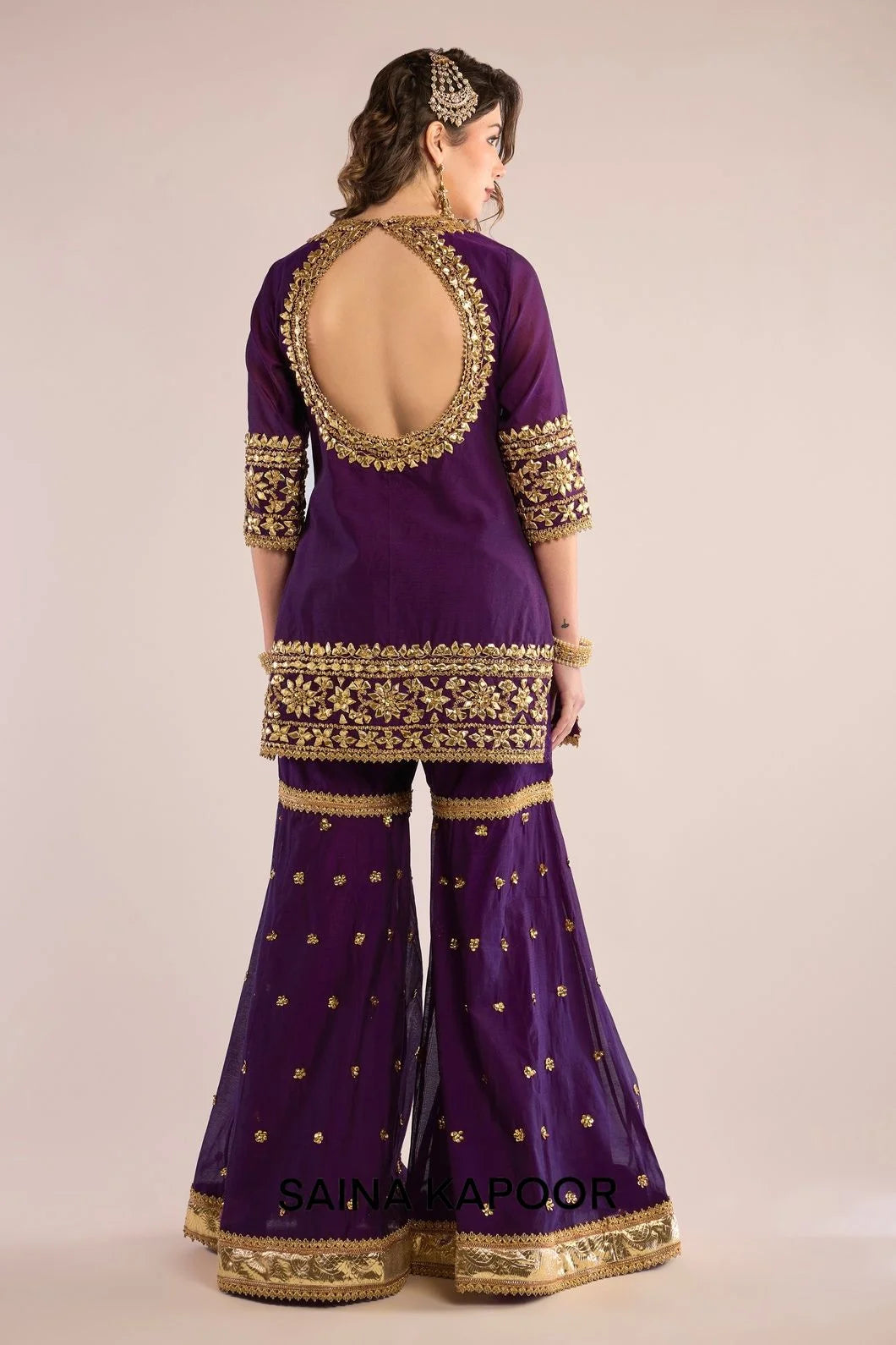 Back view of purple Chanderi kurta gharara set for women with draped purple organza dupatta — Saina Kapoor