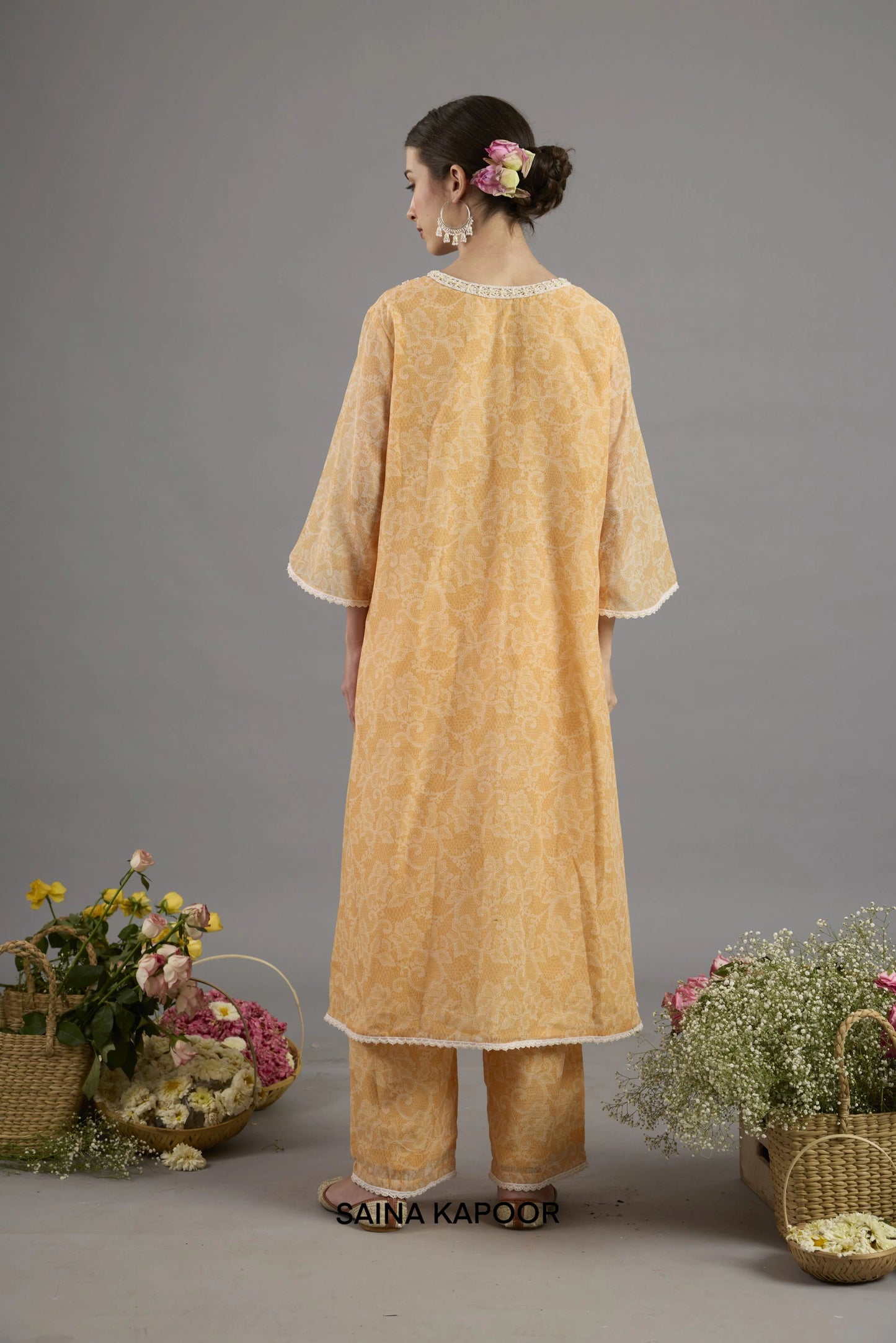Orange Chanderi kurta back view with round neckline bordered in lace and floral-printed fabric detailing - Saina Kapoor