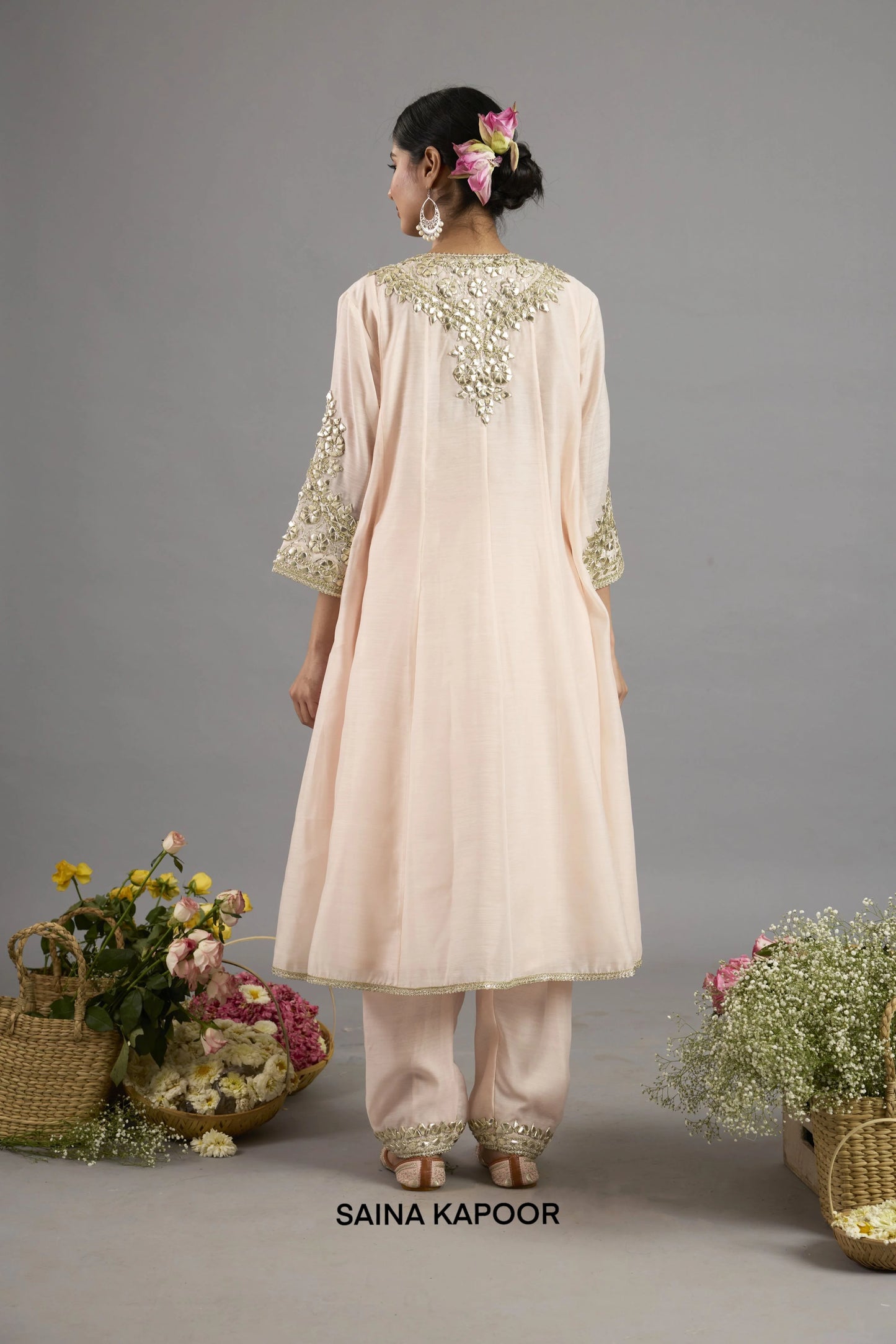Amal peach pink Chanderi Anarkali back view with gota patti embroidered panel, three-quarter sleeves with embroidered cuffs, and matching salwar - Saina Kapoor