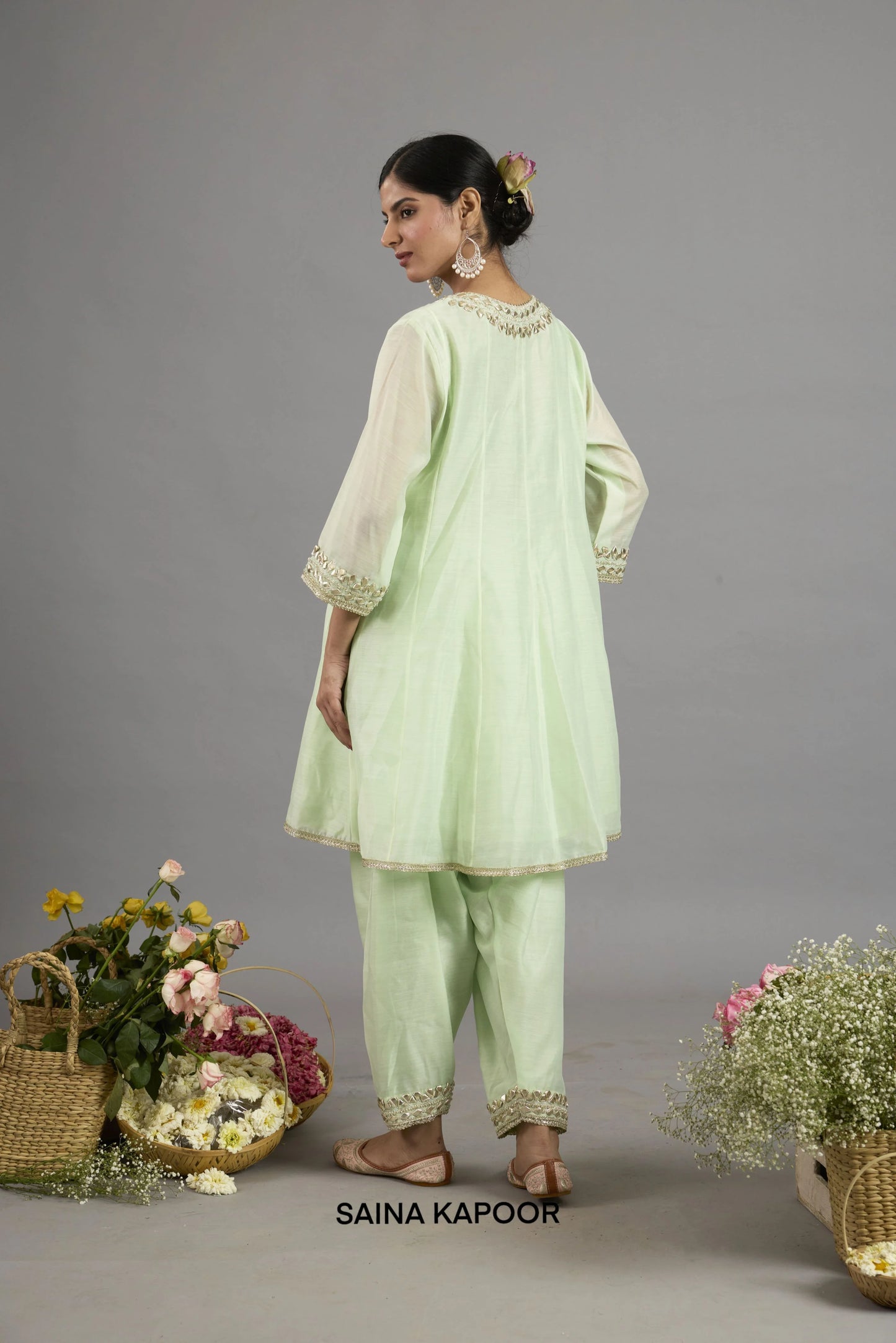 Anisah mint green Chanderi Anarkali back view with round neckline bordered in gota patti embroidery, three-quarter sleeves with embroidered cuffs, and matching salwar - Saina Kapoor