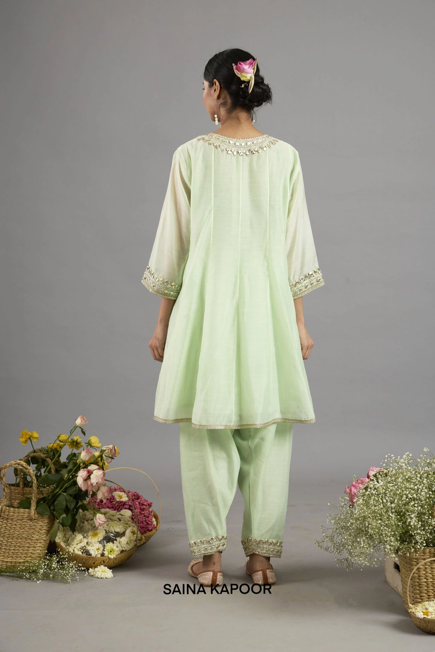 Arwa mint green long Chanderi kurta back view with round neckline, pin-tuck pleating, gota patti embroidery, three-quarter sleeves with embroidered cuffs, and matching salwar - Saina Kapoor