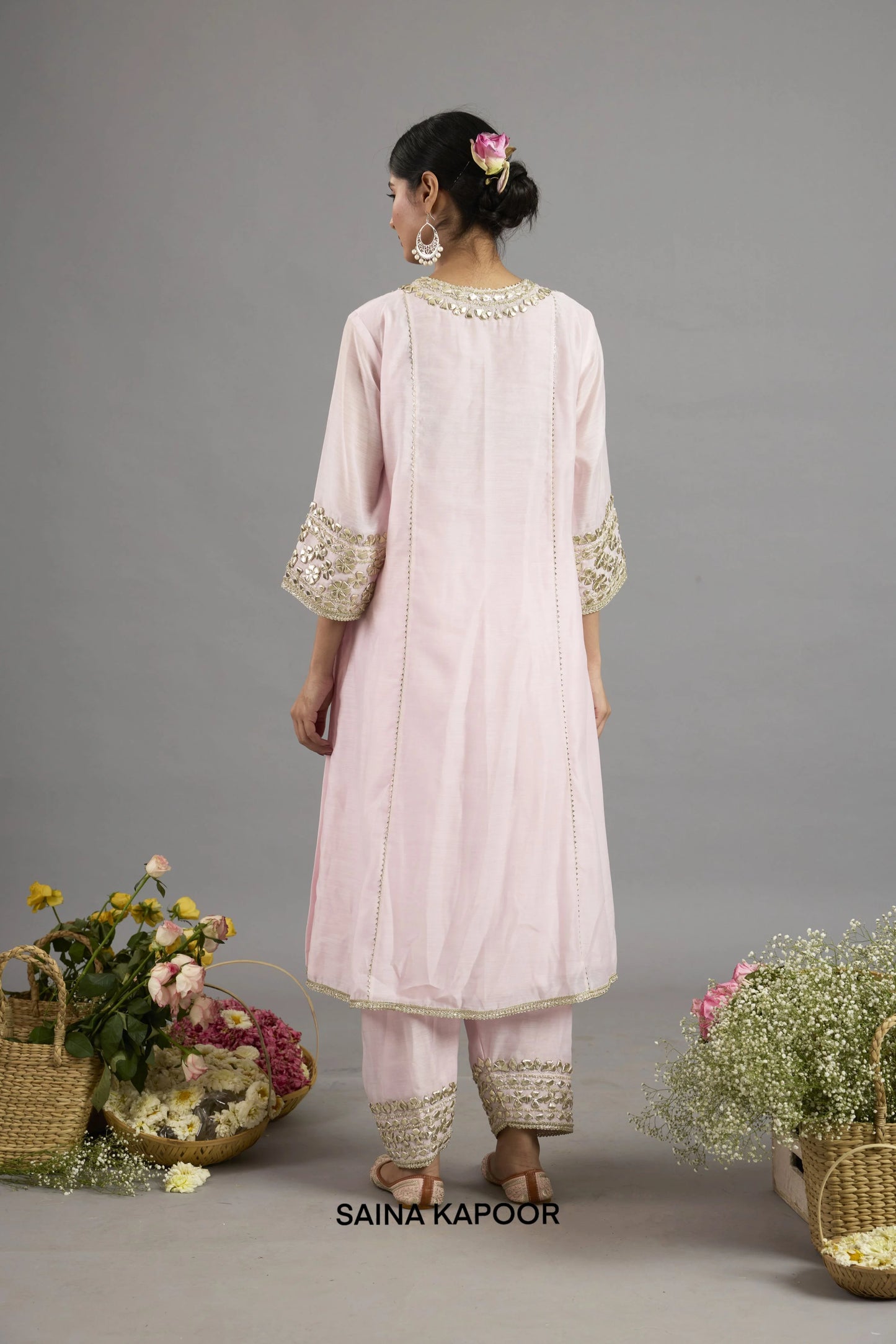Areeba baby pink long Chanderi kurta back view with round neckline, center seam, gota patti embroidery, three-quarter sleeves with embroidered cuffs, and matching salwar - Saina Kapoor