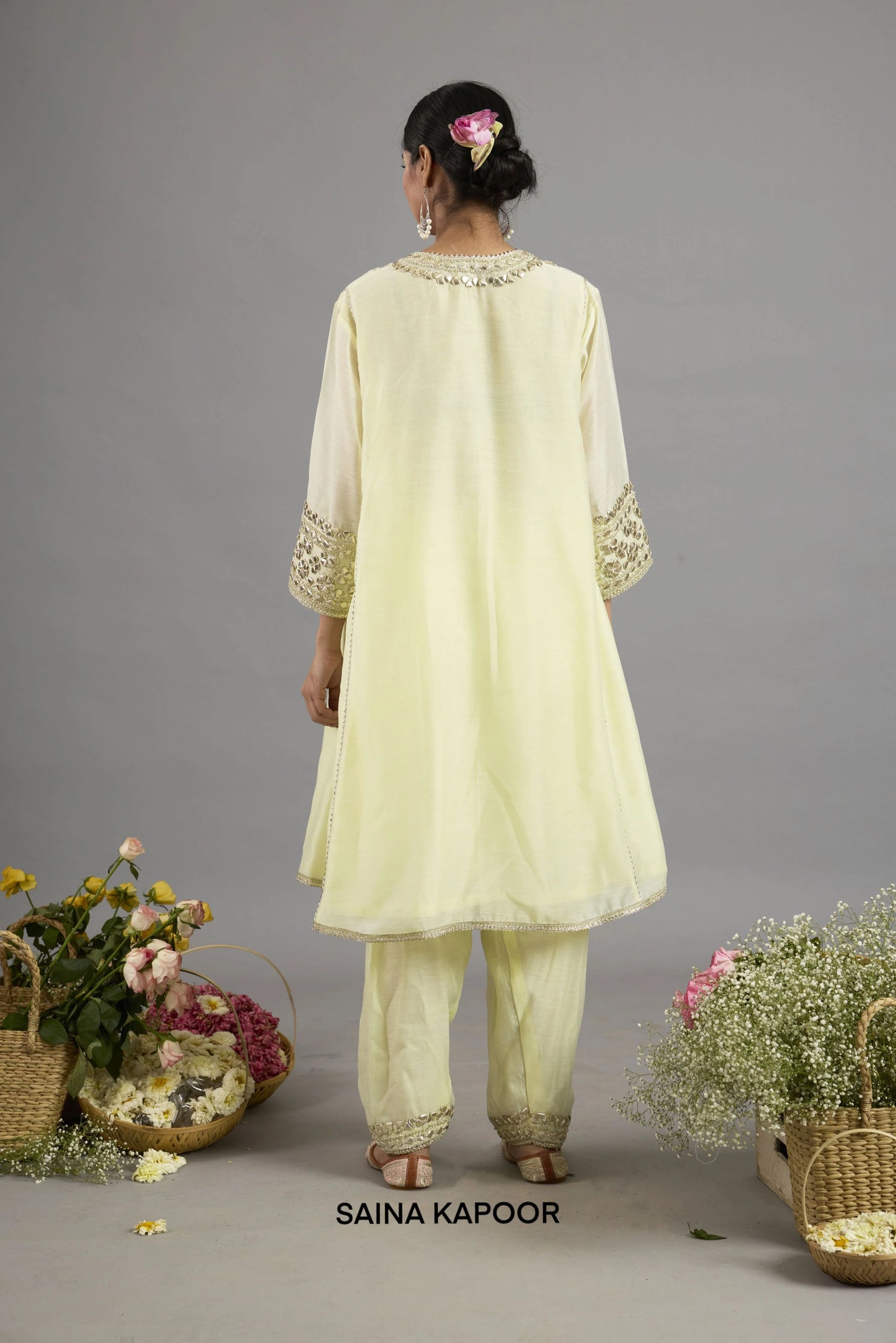 Asiya pale yellow Chanderi kurta back view with round neckline bordered in gota patti embroidery, three-quarter sleeves with embroidered cuffs, and matching salwar - Saina Kapoor