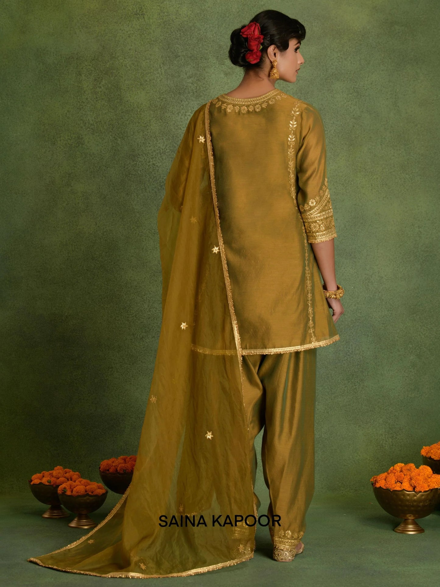 Back view of Russian Olive Chanderi short kurta with salwar and organza dupatta by Saina Kapoor