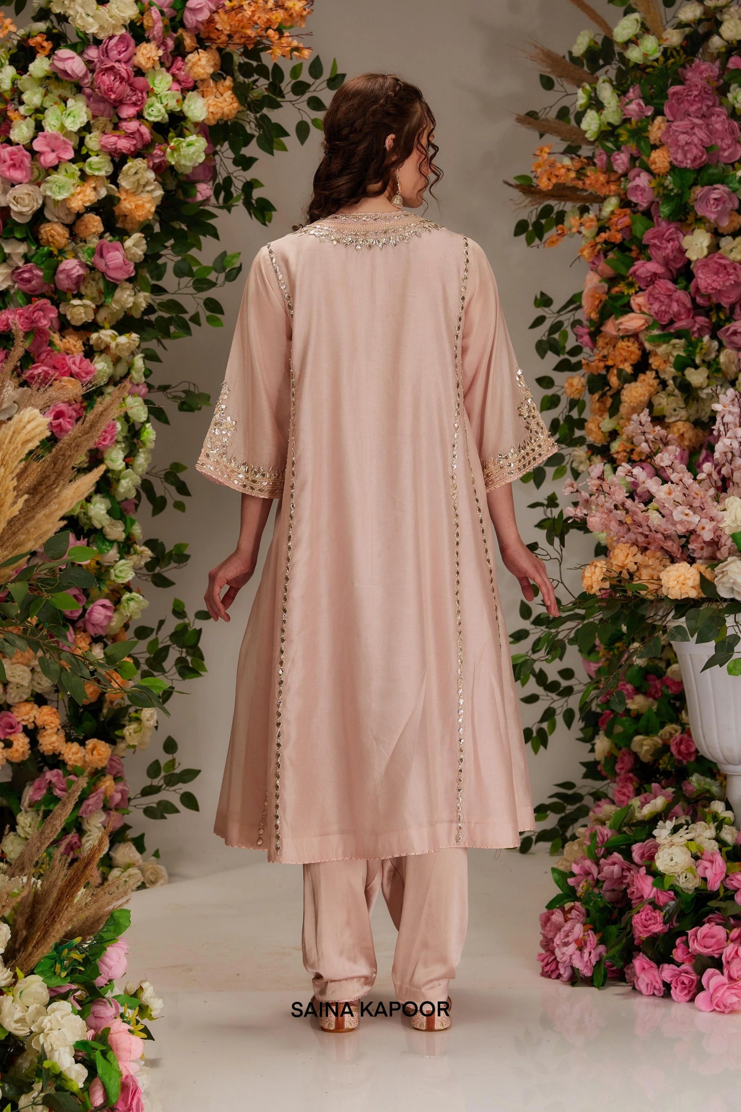 Back view of soft pink Chanderi long kalidar kurta set with flowing silhouette & organza dupatta — Saina Kapoor