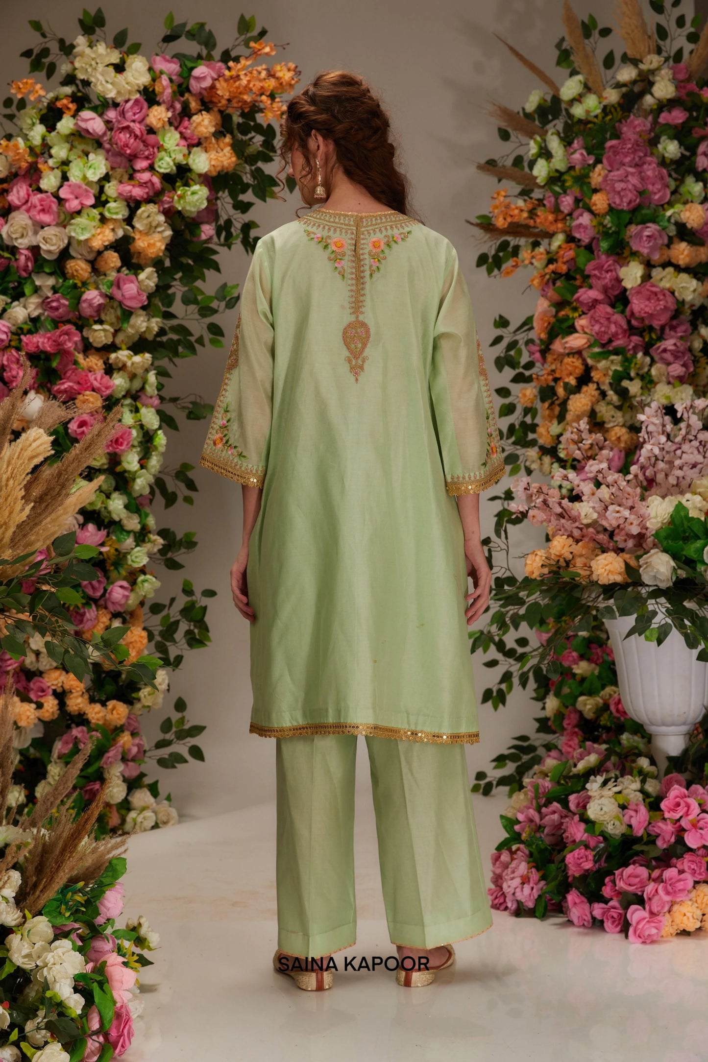 Back view of pista green Chanderi A-line kurta set for women with flowing silhouette & blush organza dupatta — Saina Kapoor