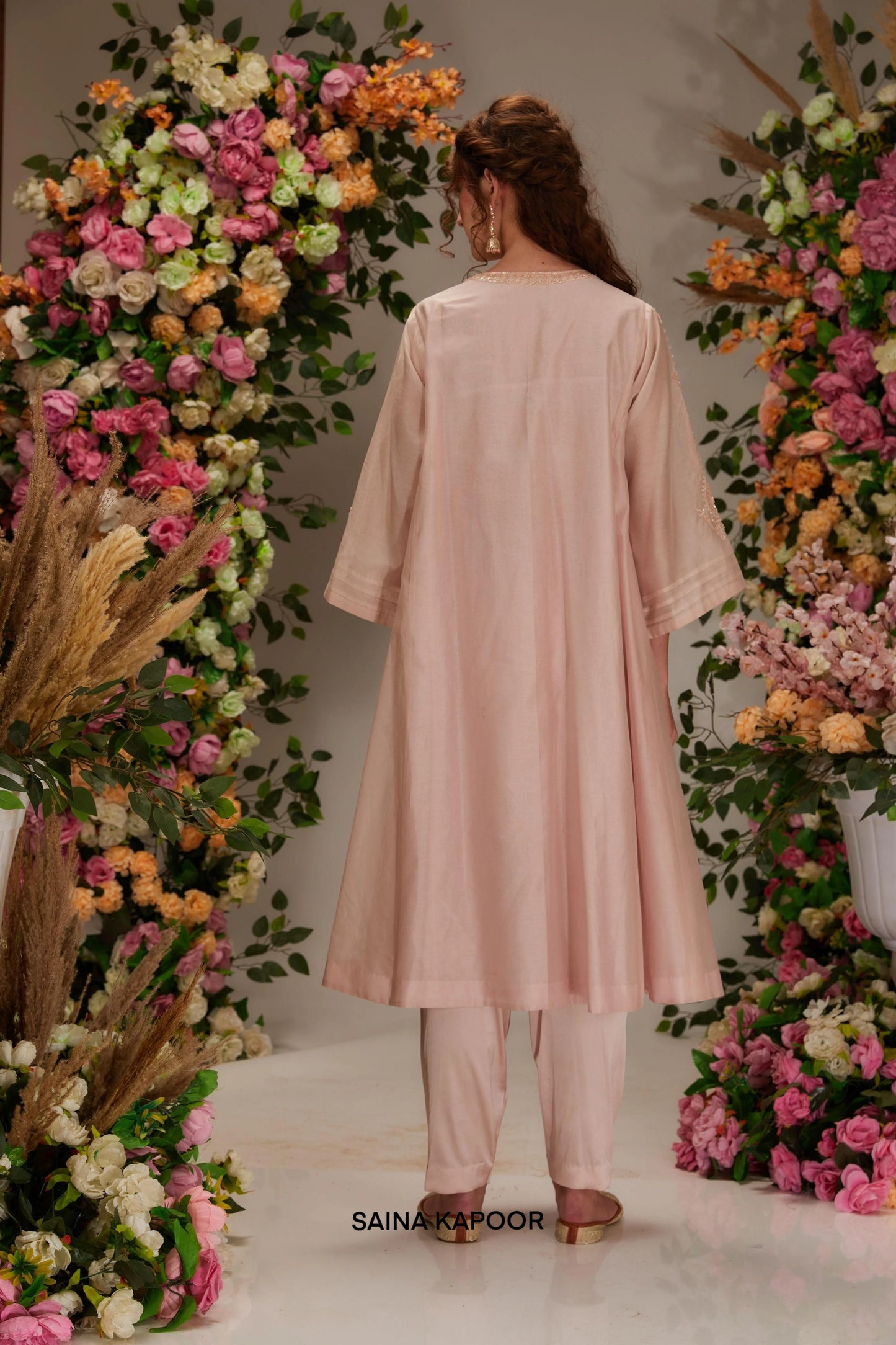 Back view of blush pink Chanderi long kalidar A-line kurta set for women with angel sleeves & matching tulip salwar — Saina Kapoor