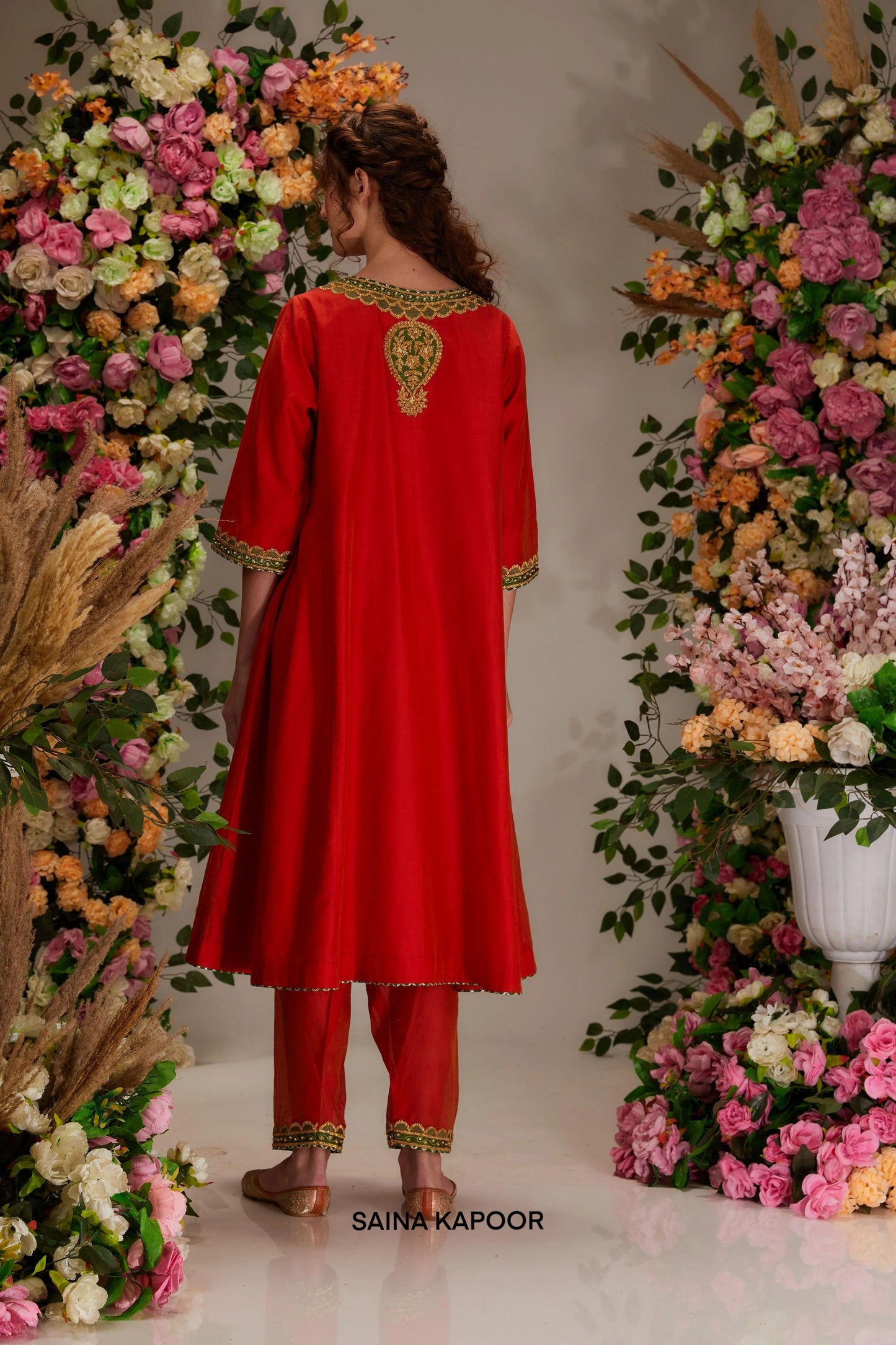 Back view of red Chanderi kalidar kurta set with elongated silhouette & olive green dupatta — Saina Kapoor